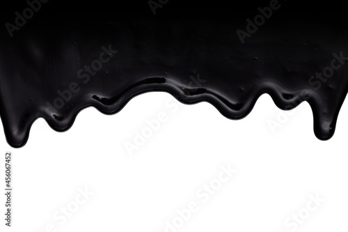Black oil-like, tar-like or resin-like liquid dripping down. Isolated on white background photo