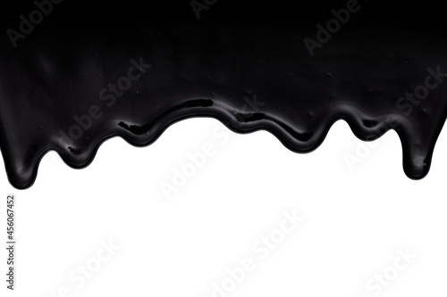 Black oil-like, tar-like or resin-like liquid dripping down. Isolated on white background