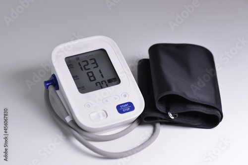Close-up of digital blood pressure monitor with indicators of measurements on the screen. 