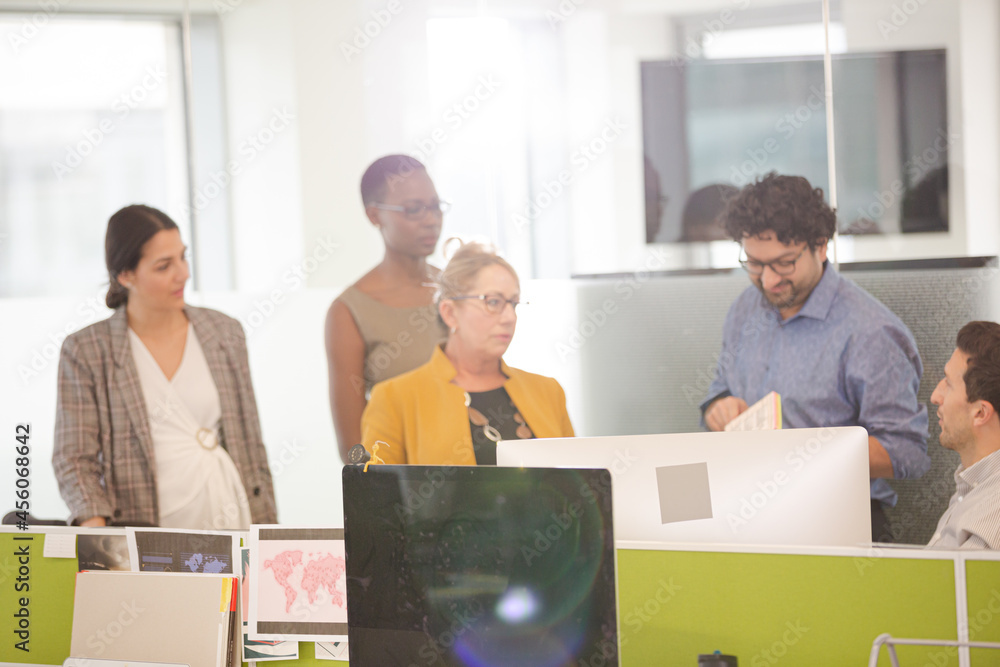 Business people talking in open plan office Business people talking in open plan office