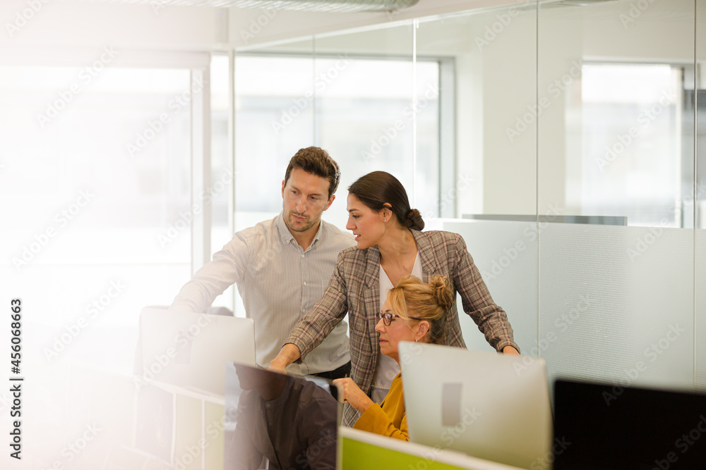 Business people brainstorming in open plan office Business people brainstorming in open plan office