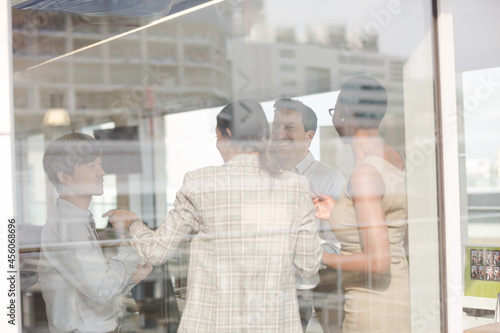 Business people talking in open plan office