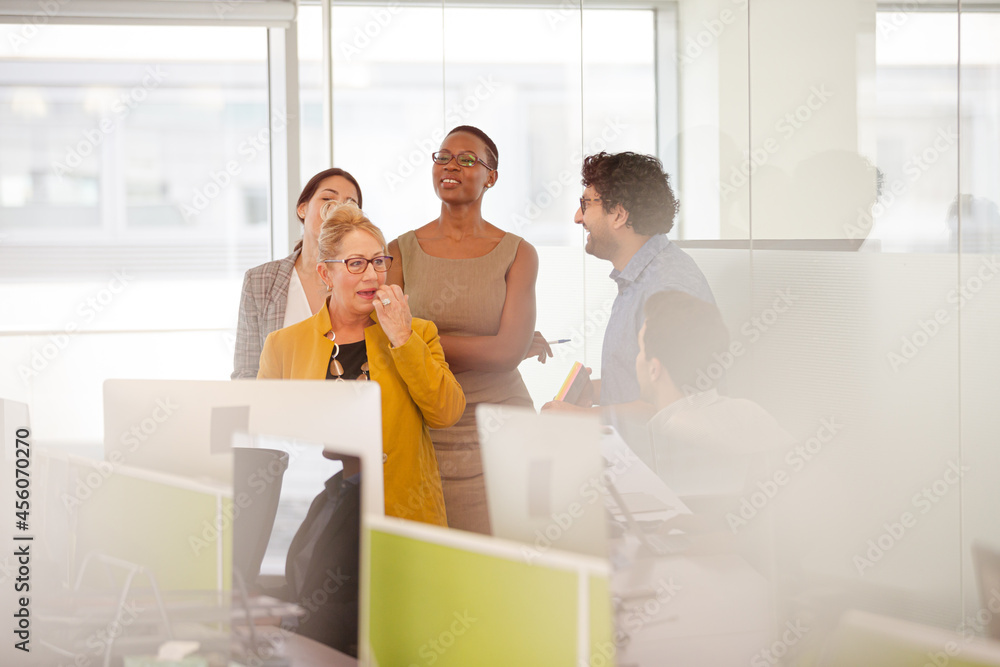 Business people talking in open plan office Business people talking in open plan office