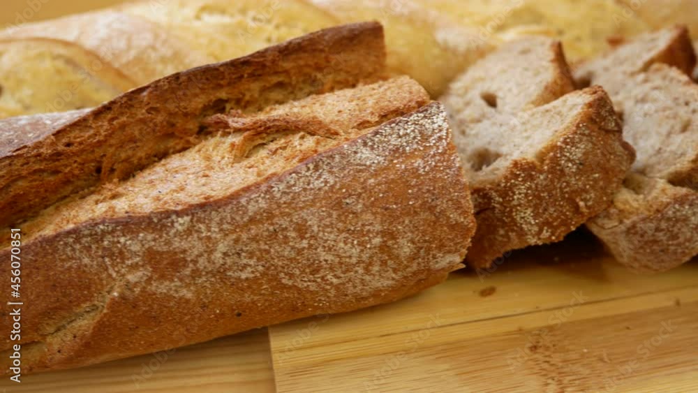 Baguette on the table. White and black bread. Sliced bread, baguette. Delicious lunch, bakery products. Panorama Baguette on the table. White and black bread. Sliced bread, baguette. Delicious lunch, bakery products. Panorama