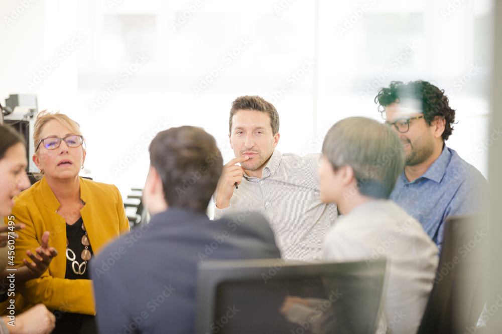 Business people brainstorming in open plan office Business people brainstorming in open plan office
