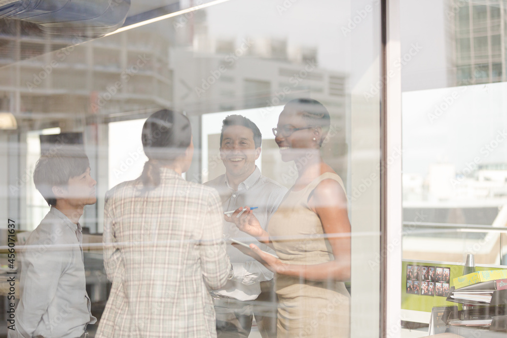 Business people talking in open plan office Business people talking in open plan office