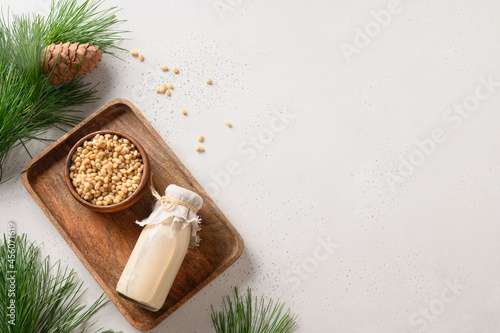 Healthy cedar nut milk on white background. Healthy vegetarian drink. Top view. Copy space. Alternative milk replacer.