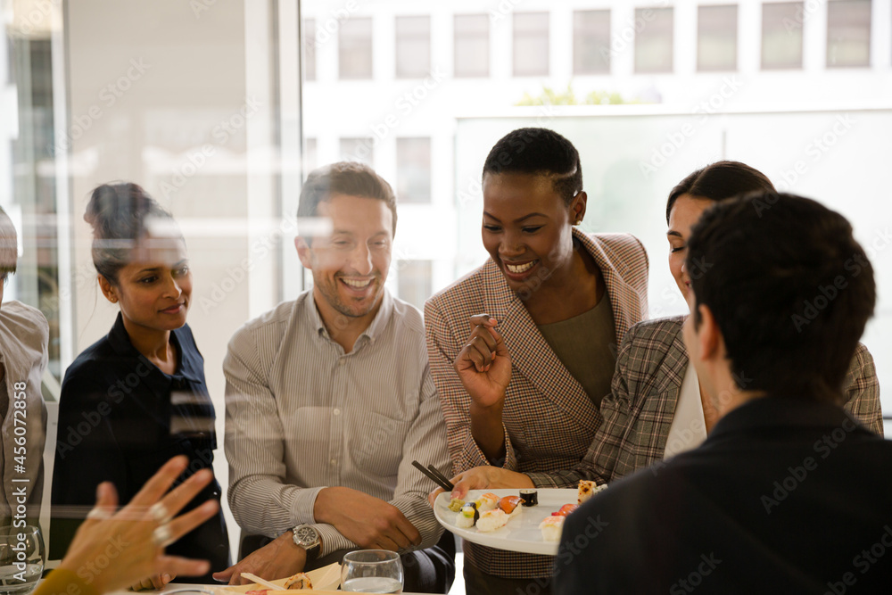 Business people enjoying sushi lunch Business people enjoying sushi lunch