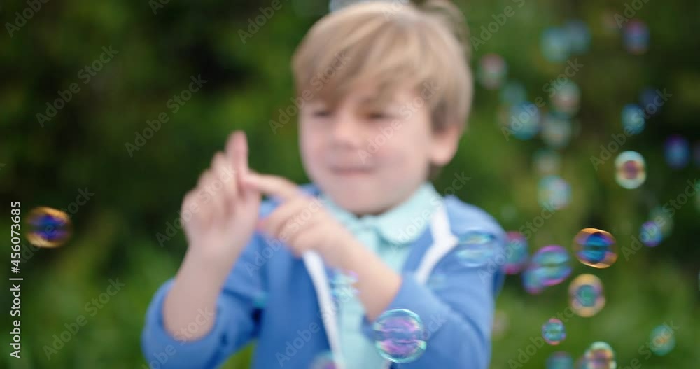 happy little boy playfully catching soap bubbles floating with cute child having fun popping bubbles in sunny park carefree childhood game 4k happy little boy playfully catching soap bubbles floating with cute child having fun popping bubbles in sunny park carefree childhood game 4k