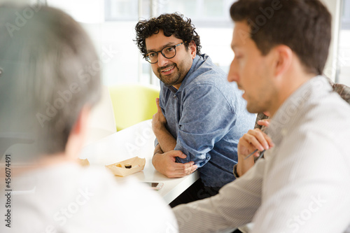 Business people enjoying sushi lunch in conference room