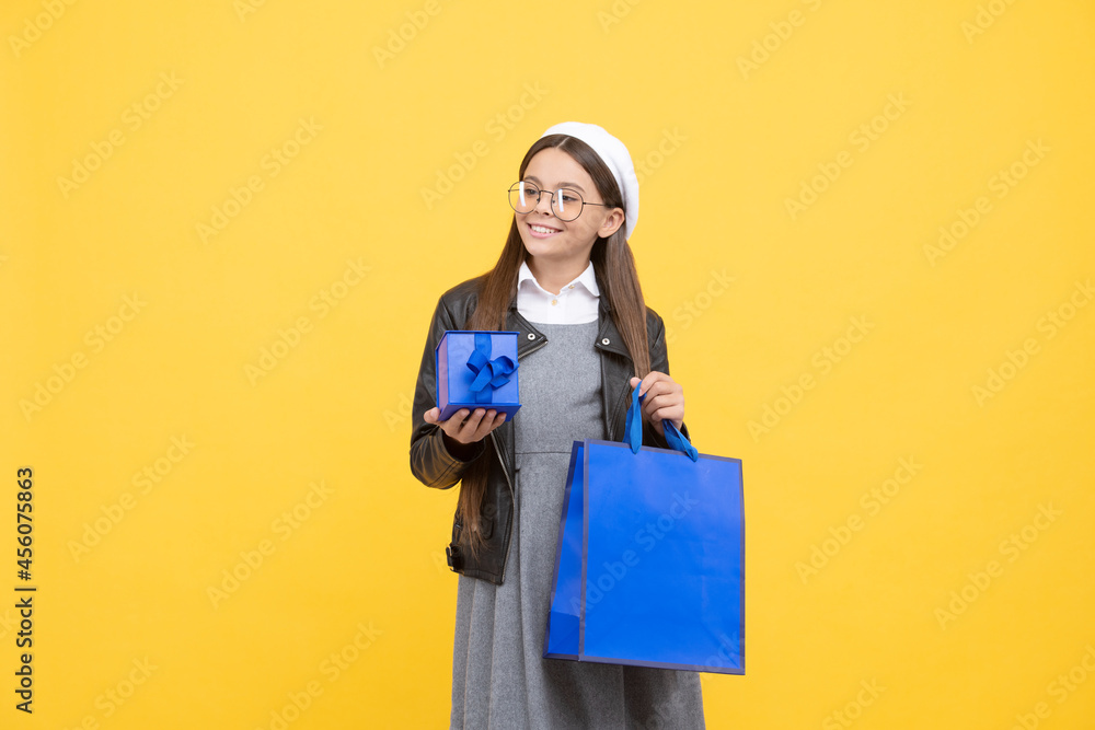 Keep bag while shopping. Happy child hold gift box and shopping bag. Back to school sale Keep bag while shopping. Happy child hold gift box and shopping bag. Back to school sale