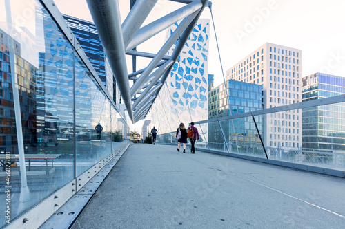 Photography couple walking on Akrobaten pedestrian bridge in Oslo, Norway