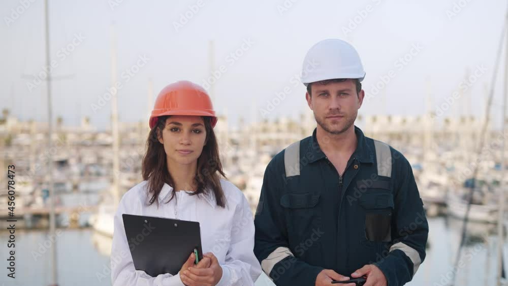 Seafarers man and woman working together in yacht club Seafarers man and woman working together in yacht club