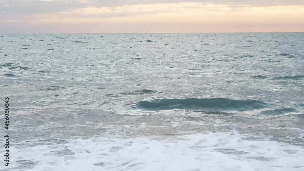 Beautiful sunset on the sea coast. Waves at sea, pebble beach. Beautiful sunset on the sea coast. Waves at sea, pebble beach.