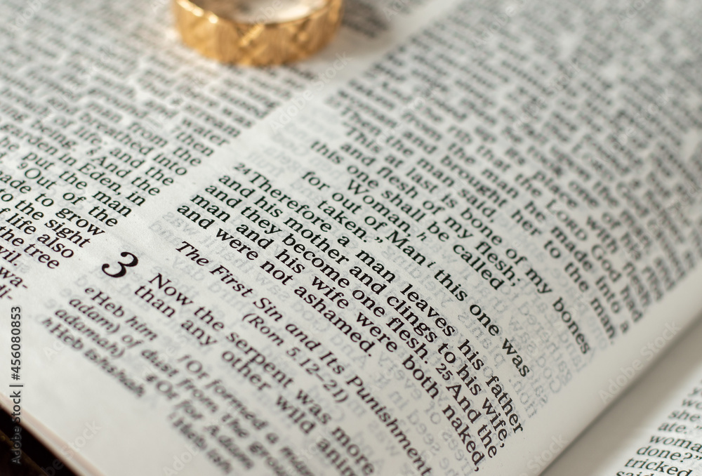 God Jesus Christ marriage and family relationship definition. Open Holy Bible Genesis 2:24. The biblical concept of faithful commitment between couples. Faithful Christian wedding ring. God Jesus Christ marriage and family relationship definition. Open Holy Bible Genesis 2:24. The biblical concept of faithful commitment between couples. Faithful Christian wedding ring.