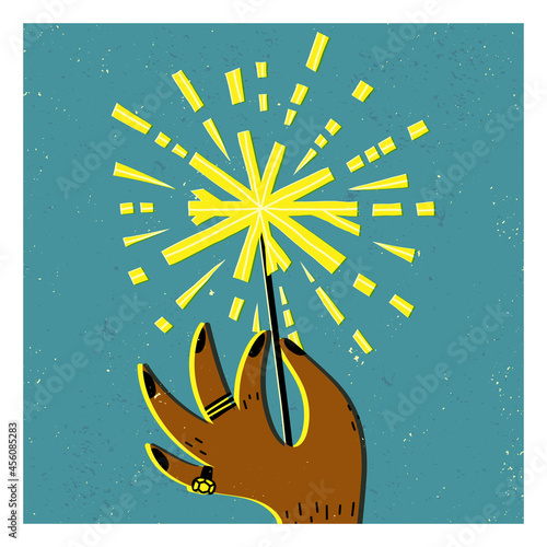A man's hand with black nails design, rings, holding a burning Bengal fire, firework sparkler. Happy New Year card.