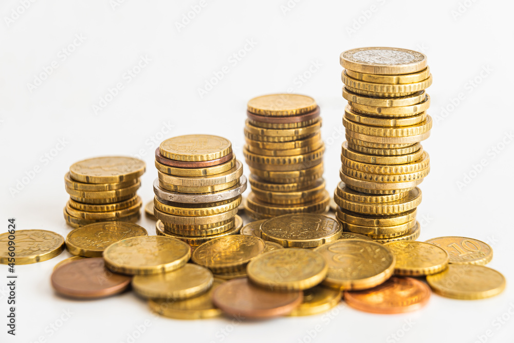 Stacks of euro coins placed on white surface. Money and value of money.
Stacks of euro coins placed on white surface. Money and value of money.