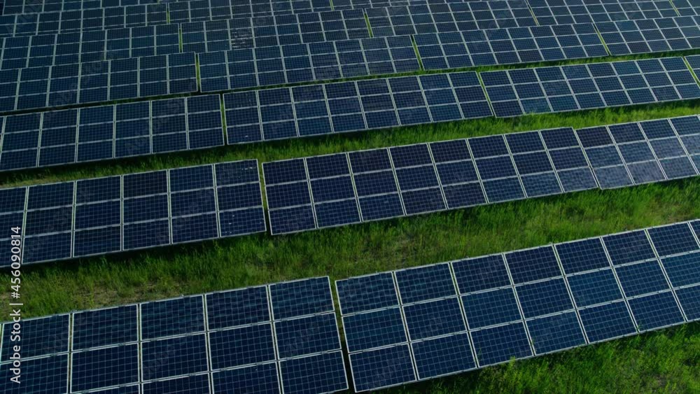 Aerial view of green field with hundreds of solar panels Aerial view of green field with hundreds of solar panels