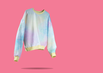 Pink Yellow Blue tie dye floating flying women's hoodie on pink background. Creative clothing concept, trendy cozy sweater. Women's fashion autumn spring discounts. black Friday. blue monday Shopping