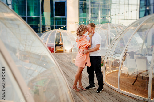 happy couple on rooftop. man and woman in love in original place for dating photo