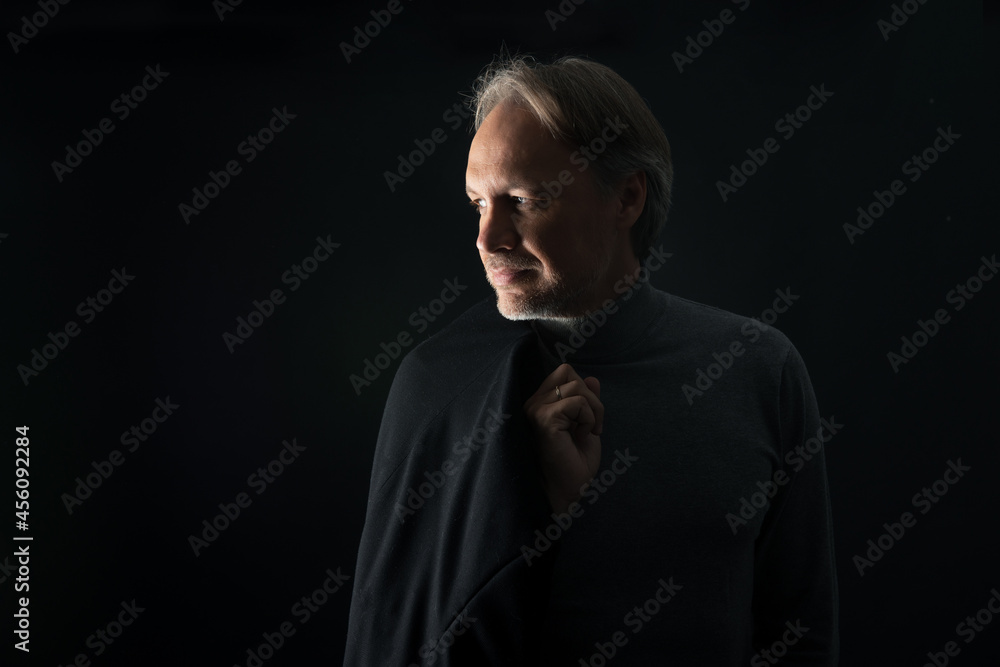 Attractive mature man with beard on plain background wearing casual Attractive mature man with beard on plain background wearing casual