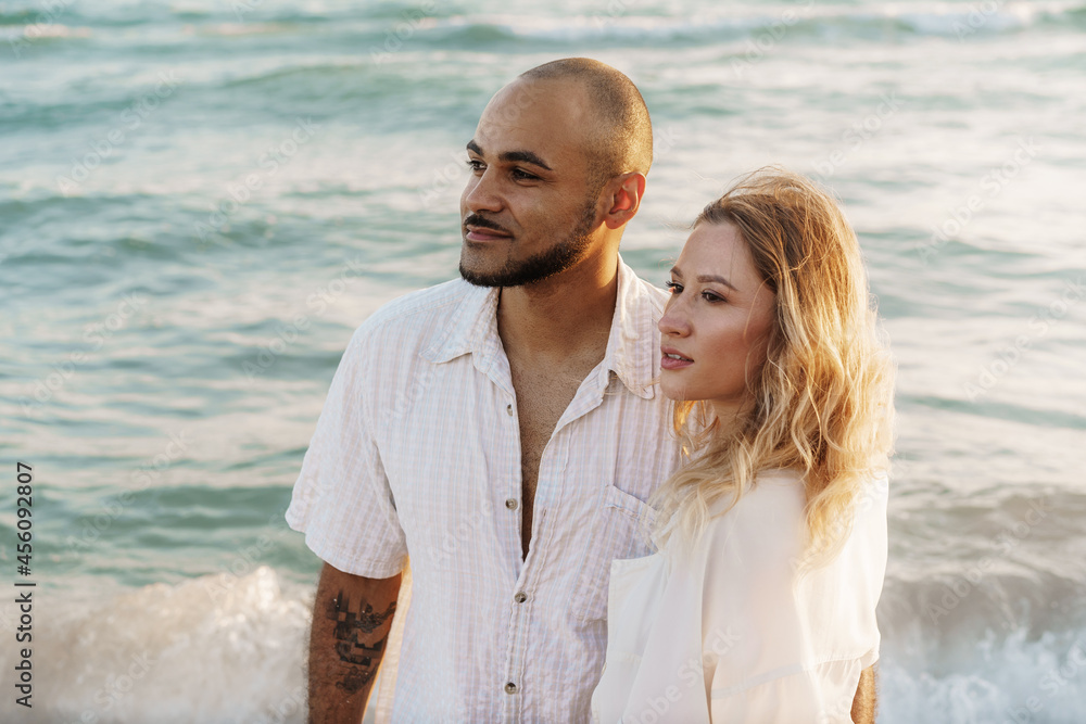 Young happy couple on seashore enjoying the sea Young happy couple on seashore enjoying the sea
