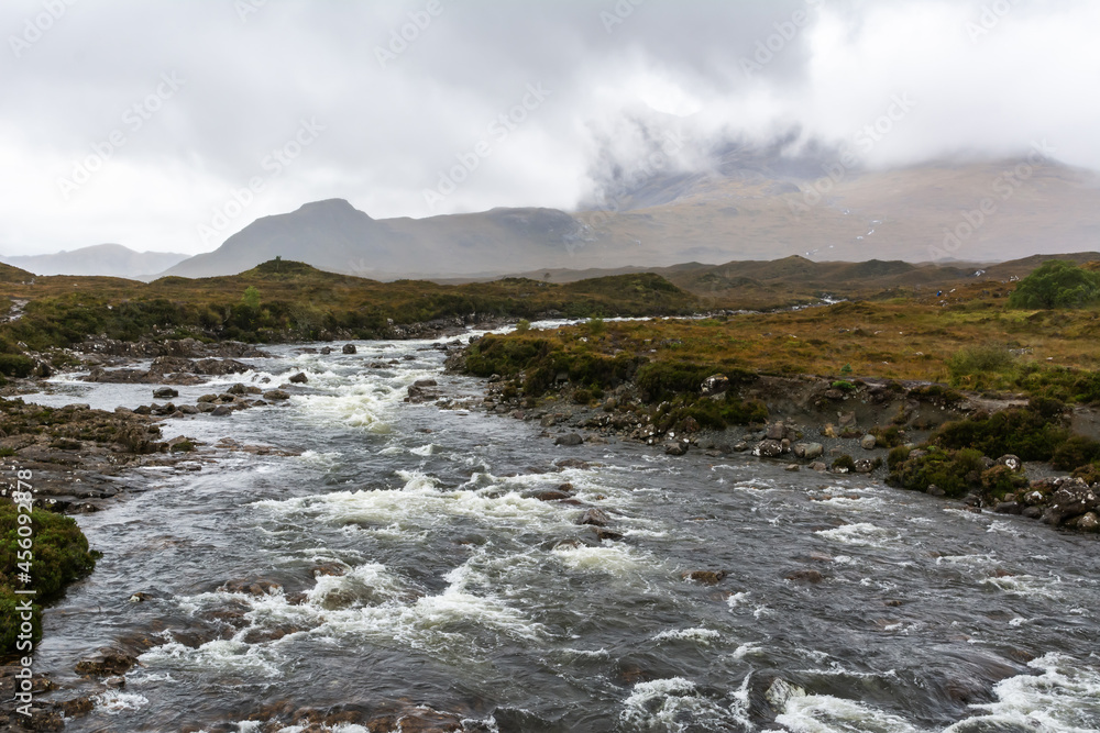 River Sligachan in the Isle of Skye in Scotland. View on a foggy day, with Cuillin mountain range in the background.