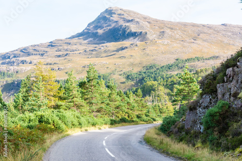 Mountainous landscape along A832 road running through the Torridon region in Scotland.