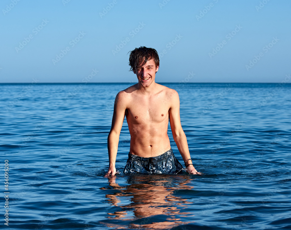 A portrait of a young handsome caucasian male in the sea