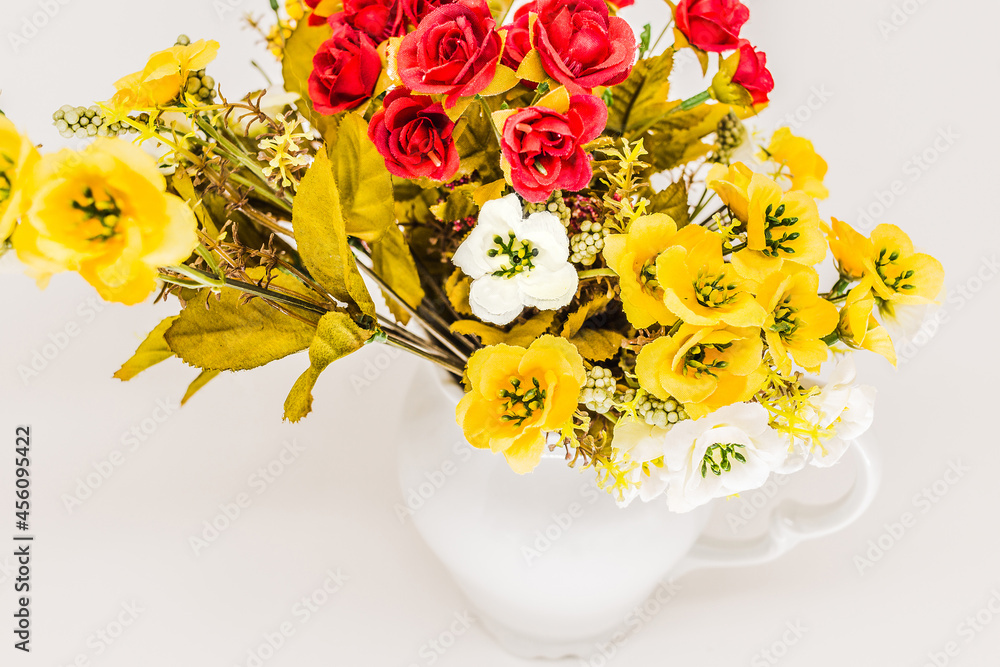 Artificial flowers in the jar. (White background/ high key/ red, white
