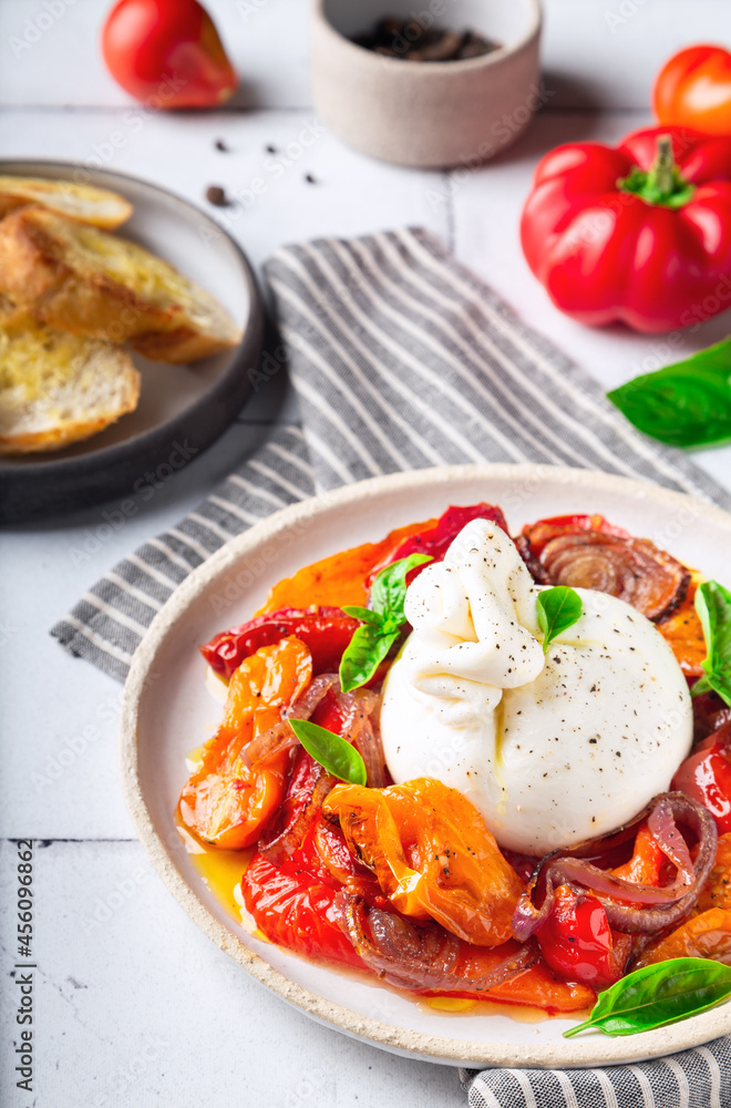 Burrata cheese with baked tomatoes, pepper, red onion and fresh basil Burrata cheese with baked tomatoes, pepper, red onion and fresh basil