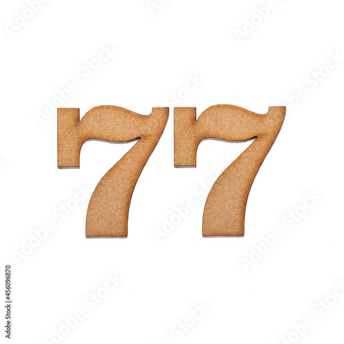 Number seventy-seven, 77 - Piece of wood isolated on white background