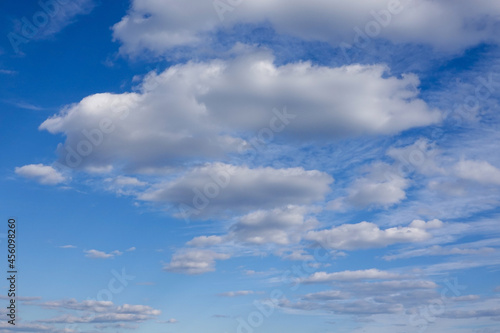 Deep blue sky behind a dramatic white puffy cloudscape