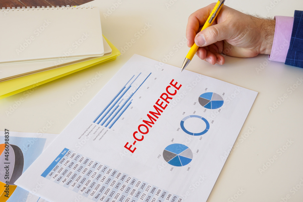 Financial concept meaning E-COMMERCE with sign on the sheet. Financial concept meaning E-COMMERCE with sign on the sheet.