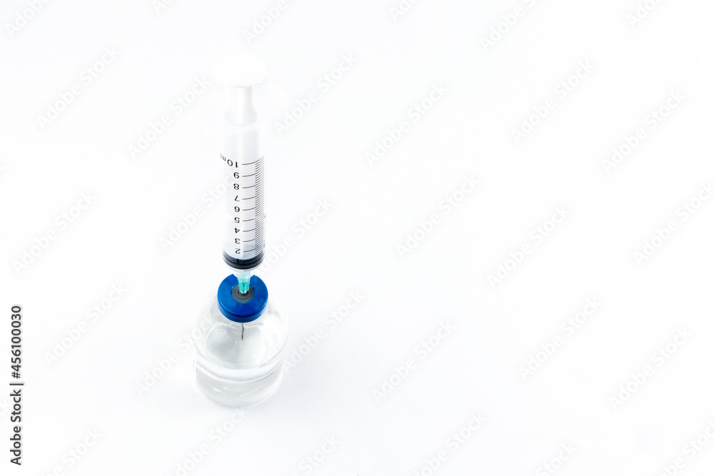 Close-up of the vial and the syringe to place the vaccine on a white background. isolated Close-up of the vial and the syringe to place the vaccine on a white background. isolated
