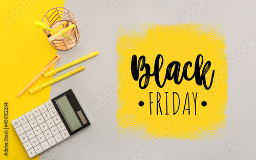 Calculator with stationery and text BLACK FRIDAY on color background