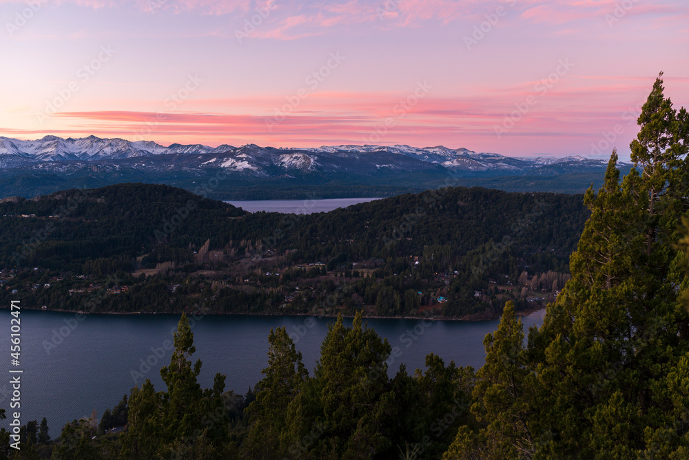 View of the Nahuel Huapi National Park at sunset. Orange sky, lakes and mountains of San Carlos de Bariloche, Patagonia, Argentina.