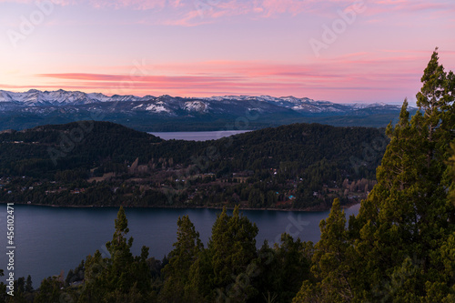 View of the Nahuel Huapi National Park at sunset. Orange sky, lakes and mountains of San Carlos de Bariloche, Patagonia, Argentina. © buenaventura13