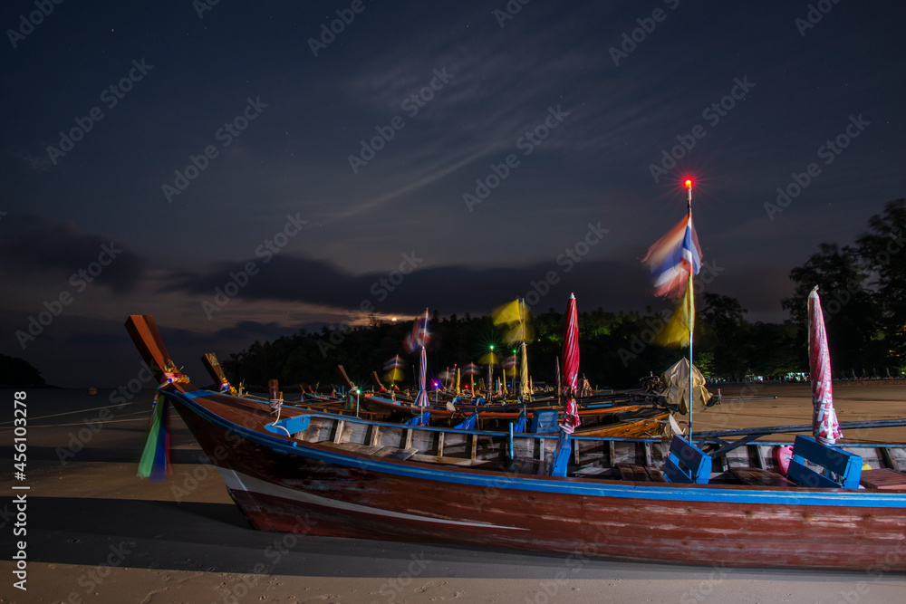 Long-tail boats stranded in the sand on Kata Beach on Phuket Island