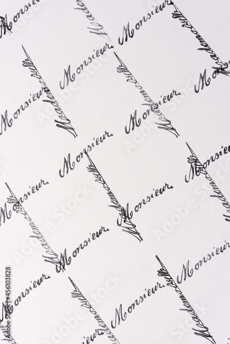 rubber stamp background with the french words monsieur and mademoiselle arranged in a grid pattern