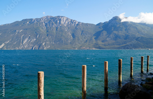 a beautiful old marina in the Italian town of Limone on turquoise lake Garda with mountains in the background (Lombardy) 