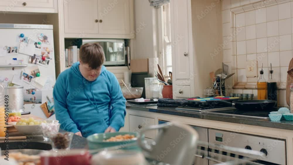 happy teenage boy with down syndrome dancing in kitchen having fun celebrating funny dance enjoying weekend at home happy teenage boy with down syndrome dancing in kitchen having fun celebrating funny dance enjoying weekend at home