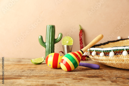 Mexican maracas and sombrero on wooden table