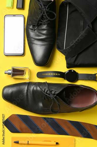 Set of stylish male accessories, mobile phone and classic leather shoes on color background © Pixel-Shot