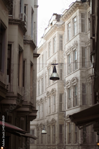 An old lantern hangs between houses on an old street in Istanbul 