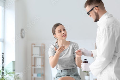 Doctor disinfecting hand of...