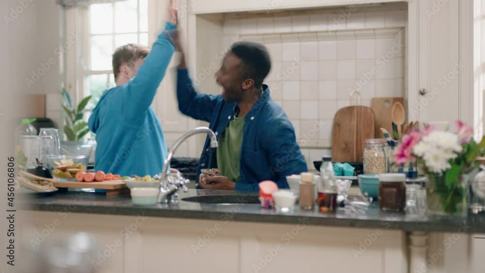 multi ethnic father and son dancing in kitchen teenage boy with down syndrome having fun dance with dad celebrating happy family at home multi ethnic father and son dancing in kitchen teenage boy with down syndrome having fun dance with dad celebrating happy family at home