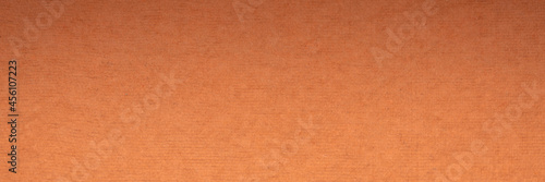 background and texture of orange handmade Indian rag paper created from recycled cotton fabric, panoramic banner