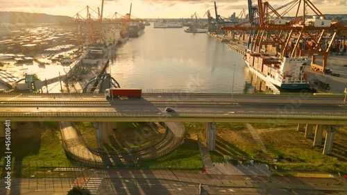 Aerial View Of Vehicles Driving On Elevated Road At Dusk Passing By Port In Gdynia, Poland. photo