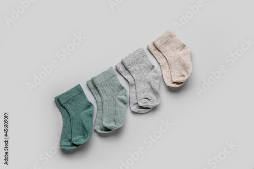 Different baby socks on grey background